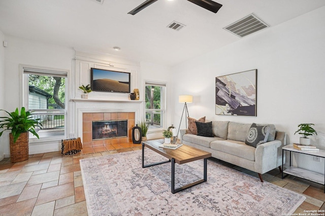 1159 Bluff Frst, San Antonio, TX 78248 - living area with a ceiling fan, a fireplace, and stone tile flooring