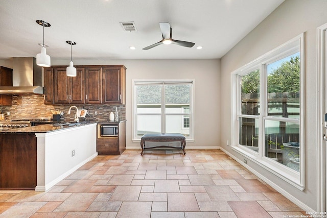1159 Bluff Frst, San Antonio, TX 78248 - kitchen with wall chimney range hood, stainless steel microwave, ceiling fan, healthy amount of natural light, and recessed lighting
