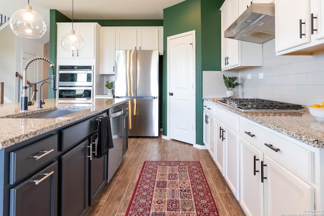 5944 Sterling Vw, Schertz, TX 78108 - kitchen with range hood, appliances with stainless steel finishes, backsplash, hanging light fixtures, and white cabinetry