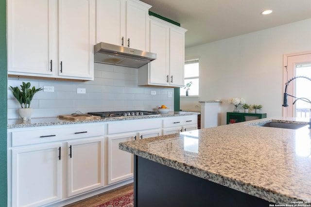 5944 Sterling Vw, Schertz, TX 78108 - kitchen featuring stainless steel gas cooktop, under cabinet range hood, healthy amount of natural light, white cabinetry, and recessed lighting