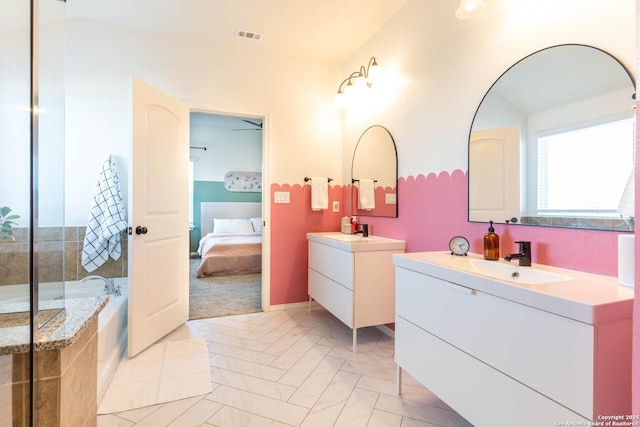 5944 Sterling Vw, Schertz, TX 78108 - ensuite bathroom featuring plenty of natural light, two vanities, and a garden tub
