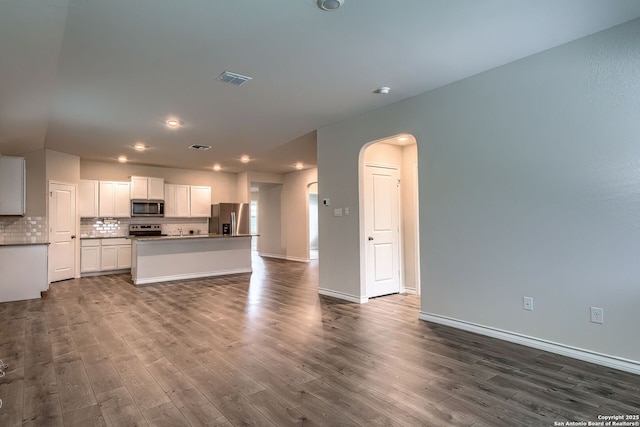3008 Pemberton Post, San Antonio, TX 78245 - kitchen with stainless steel appliances, dark wood-type flooring, arched walkways, backsplash, and recessed lighting