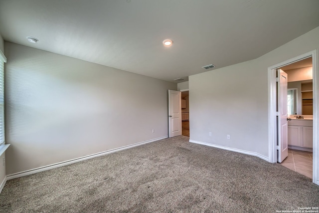 3008 Pemberton Post, San Antonio, TX 78245 - unfurnished bedroom featuring light carpet and ensuite bathroom