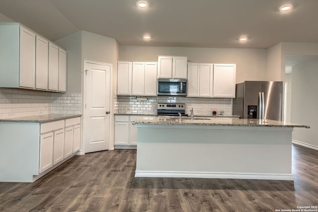 3008 Pemberton Post, San Antonio, TX 78245 - kitchen with stainless steel appliances, light stone countertops, backsplash, a kitchen island with sink, and dark wood finished floors