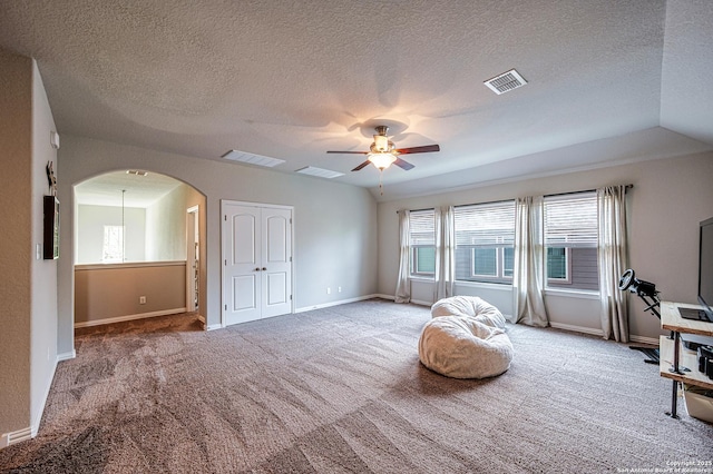 13942 Evelina, San Antonio, TX 78253 - living area with carpet floors, a ceiling fan, arched walkways, and a textured ceiling