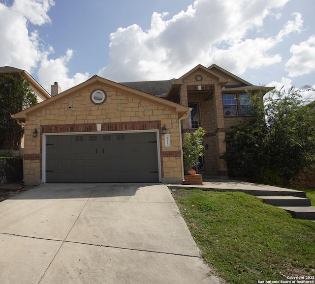 24123 Horse Pr, San Antonio, TX 78261 - view of front facade featuring concrete driveway, an attached garage, stone siding, and a front yard