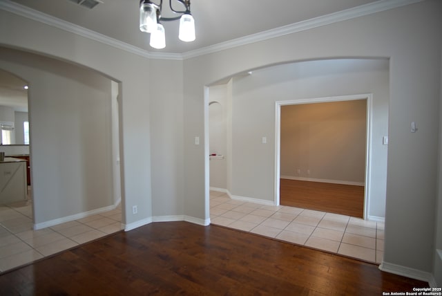 24123 Horse Pr, San Antonio, TX 78261 - unfurnished room with wood finished floors, crown molding, arched walkways, and a chandelier
