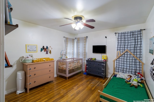 450 Pamela, San Antonio, TX 78223 - bedroom featuring hardwood / wood-style flooring, a crib, and a ceiling fan