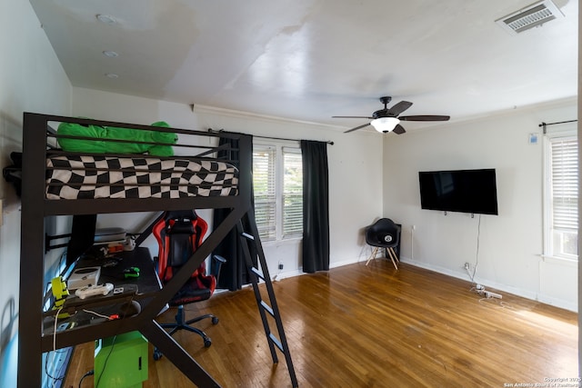 450 Pamela, San Antonio, TX 78223 - bedroom featuring wood finished floors, multiple windows, and ceiling fan