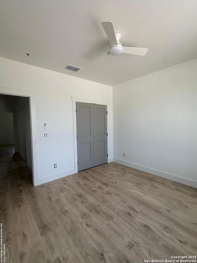 129 Merion Ln, Vernia, TX 78121 - unfurnished bedroom featuring wood finished floors, a closet, and ceiling fan