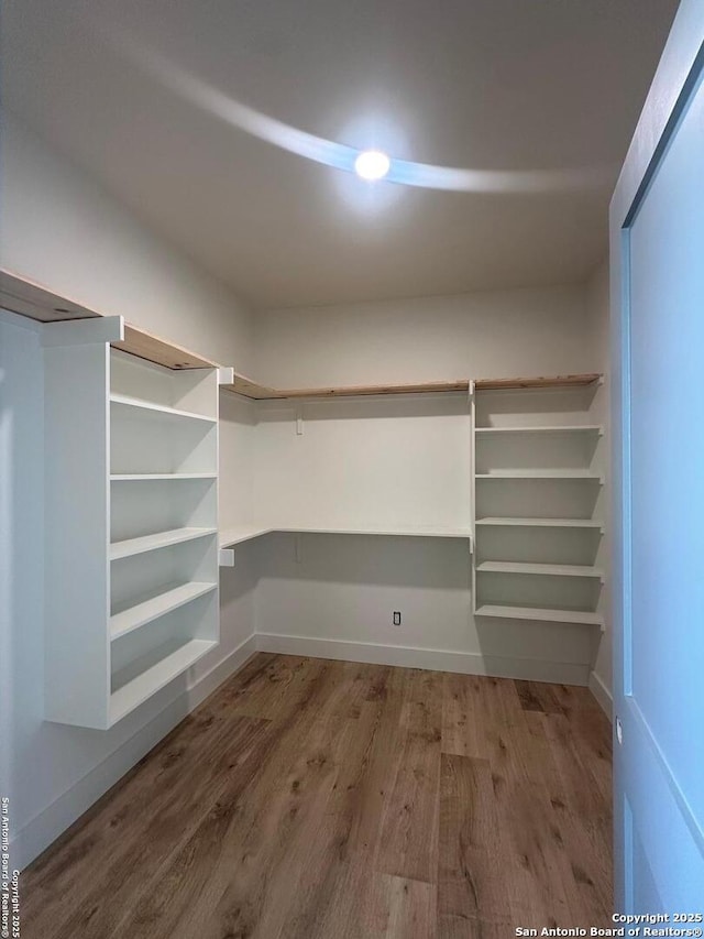 129 Merion Ln, Vernia, TX 78121 - walk in closet featuring wood finished floors