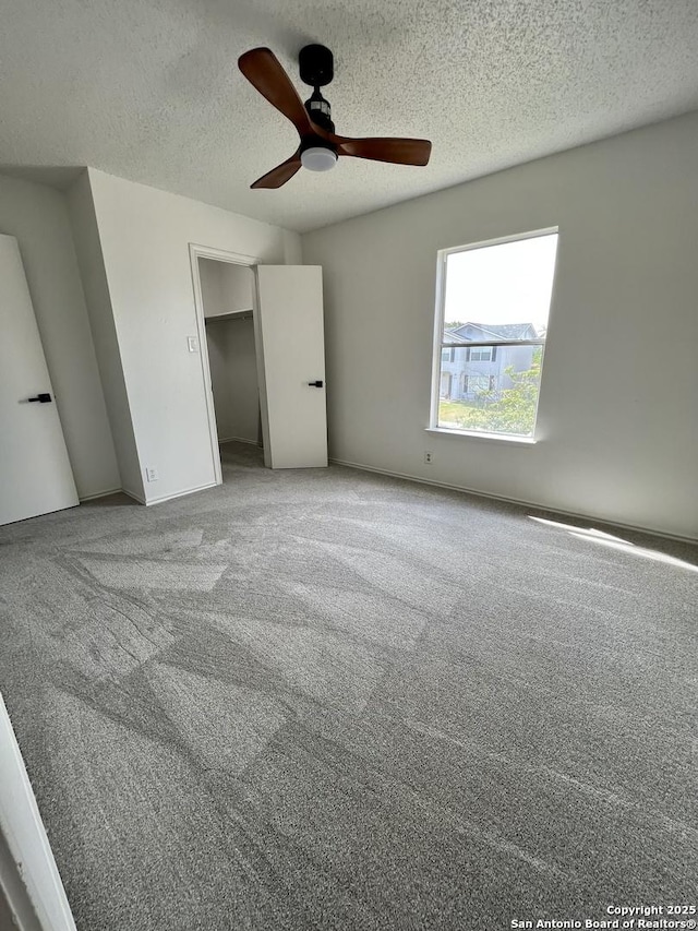 7947 Ruby Mdws, San Antonio, TX 78251 - unfurnished bedroom featuring carpet, a textured ceiling, a ceiling fan, and a closet