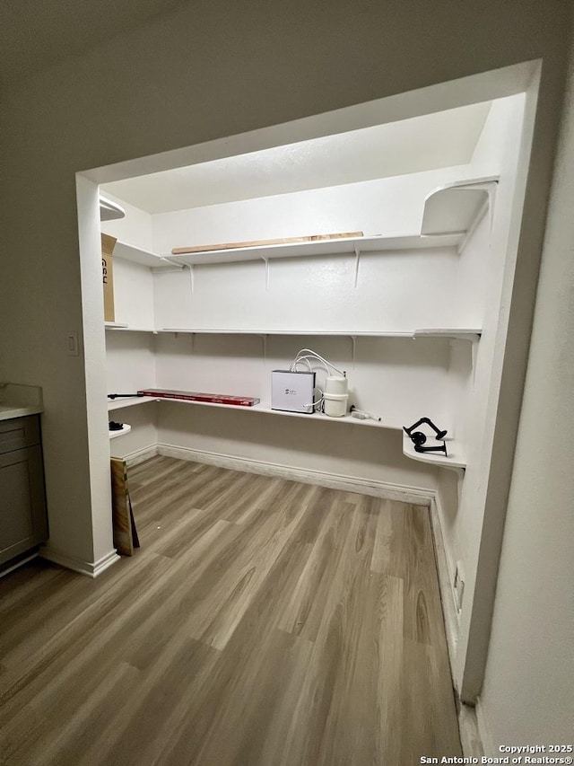 7947 Ruby Mdws, San Antonio, TX 78251 - laundry room featuring wood finished floors and baseboards