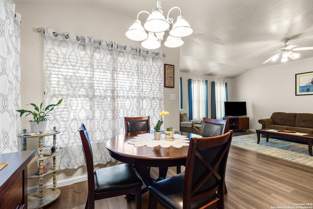 9235 Everton, San Antonio, TX 78245 - dining room with vaulted ceiling, wood finished floors, a chandelier, and ceiling fan