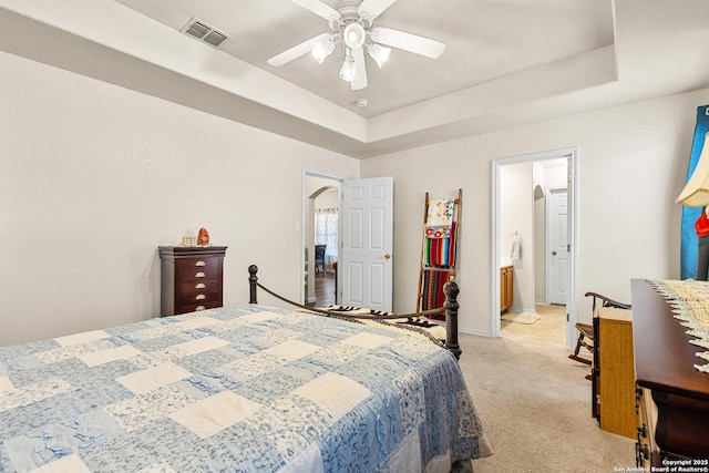9235 Everton, San Antonio, TX 78245 - bedroom featuring light colored carpet, arched walkways, a raised ceiling, ceiling fan, and ensuite bathroom