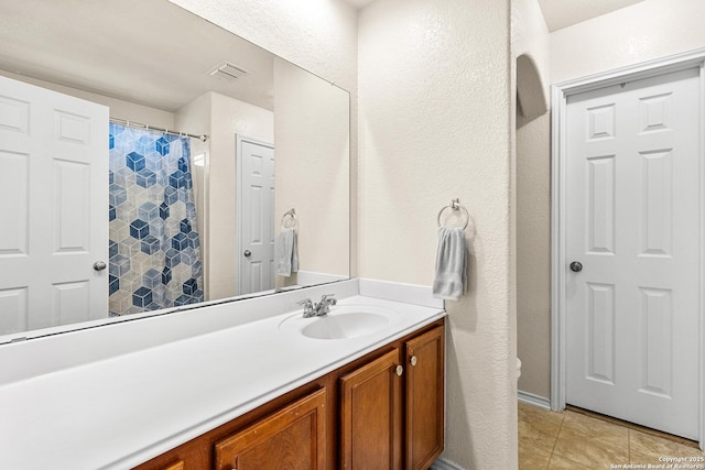 9235 Everton, San Antonio, TX 78245 - bathroom featuring vanity, tile patterned floors, and a textured wall