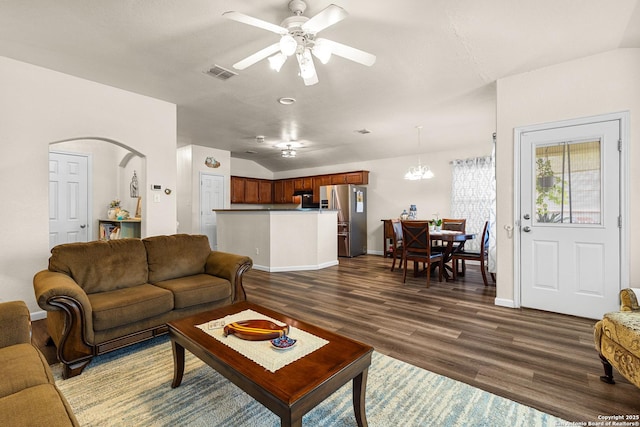 9235 Everton, San Antonio, TX 78245 - living area featuring dark wood finished floors, vaulted ceiling, a ceiling fan, a chandelier, and arched walkways