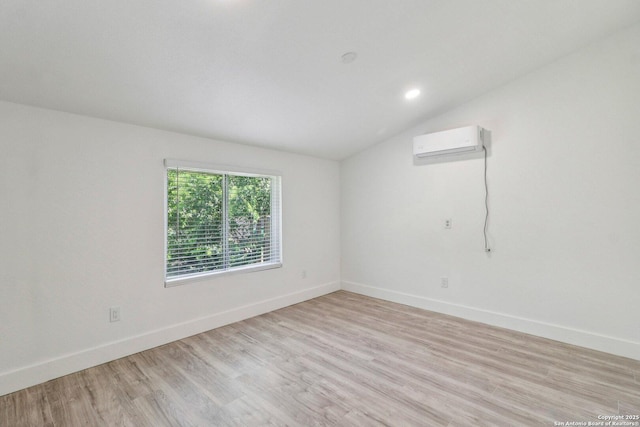 937 Anderson, Seguin, TX 78155 - spare room featuring a wall mounted AC, lofted ceiling, and light wood-type flooring