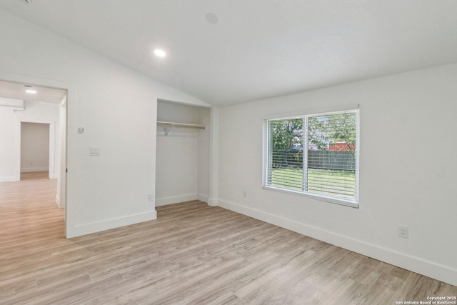 937 Anderson, Seguin, TX 78155 - unfurnished bedroom with vaulted ceiling, light wood-style flooring, a closet, an AC wall unit, and recessed lighting