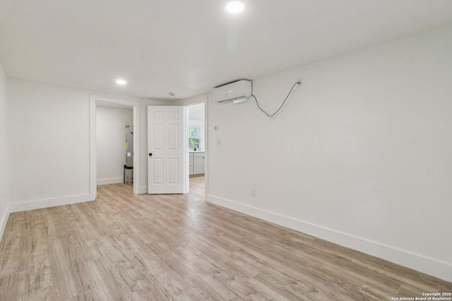 937 Anderson, Seguin, TX 78155 - unfurnished room featuring an AC wall unit, light wood-style flooring, and recessed lighting