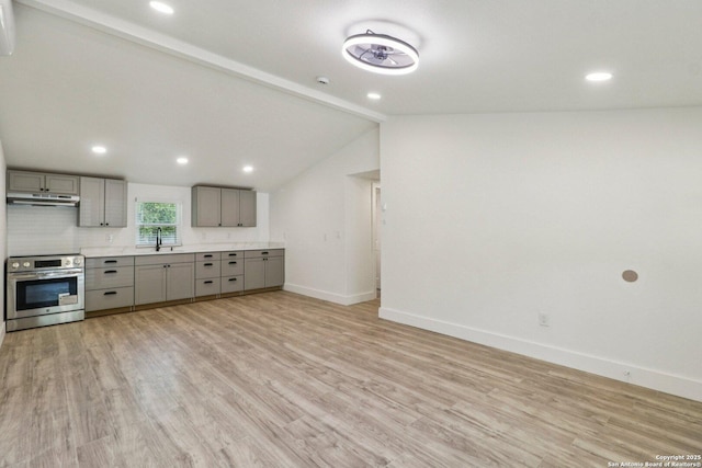 937 Anderson, Seguin, TX 78155 - kitchen featuring gray cabinetry, stainless steel range with electric cooktop, under cabinet range hood, light wood-style flooring, and lofted ceiling