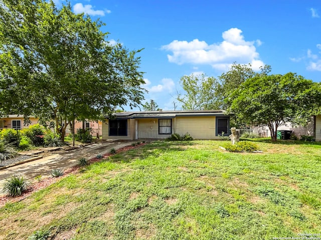 261 Shelburn, San Antonio, TX 78220 - view of front of house featuring a front yard, roof mounted solar panels, and concrete driveway
