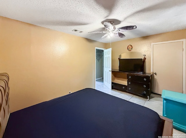 261 Shelburn, San Antonio, TX 78220 - bedroom with a textured ceiling, a ceiling fan, and tile patterned floors