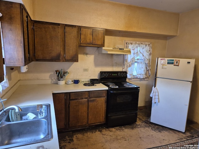 337 Pendleton, San Antonio, TX 78204 - kitchen with electric range, freestanding refrigerator, light countertops, under cabinet range hood, and dark brown cabinetry