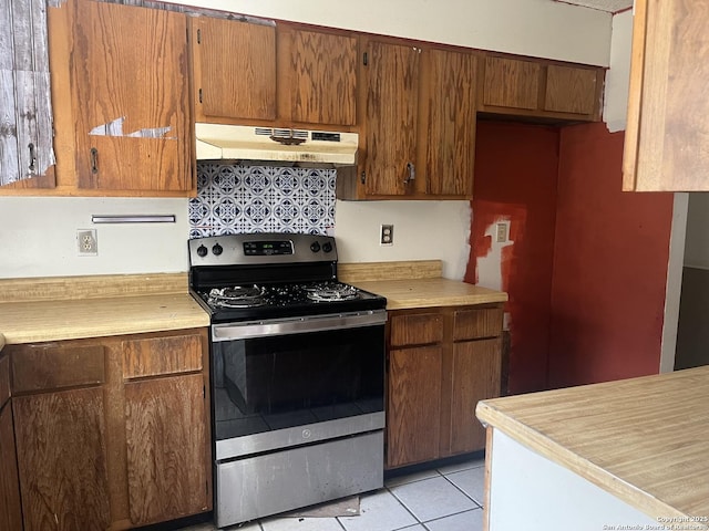 5212 Vinecrest, Kirby, TX 78219 - kitchen with stainless steel electric range, under cabinet range hood, light countertops, and light tile patterned floors
