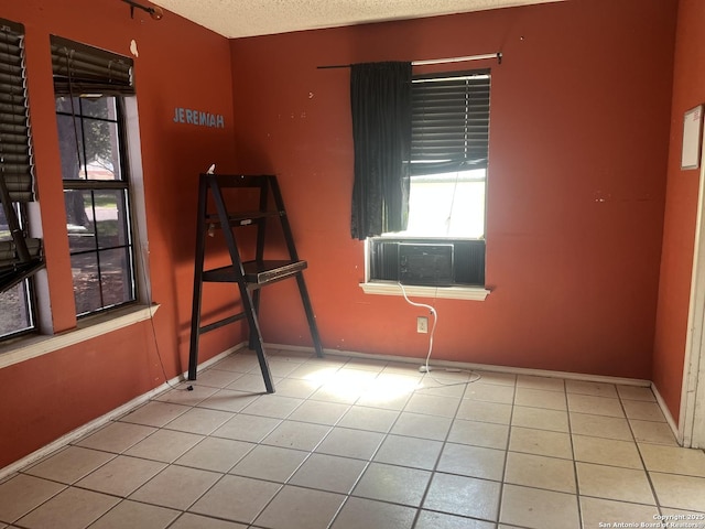 5212 Vinecrest, Kirby, TX 78219 - tiled empty room with healthy amount of natural light, cooling unit, and a textured ceiling