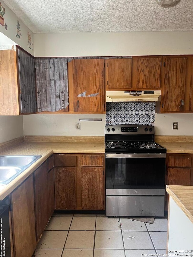 5212 Vinecrest, Kirby, TX 78219 - kitchen featuring stainless steel electric range, under cabinet range hood, light countertops, a textured ceiling, and dishwashing machine
