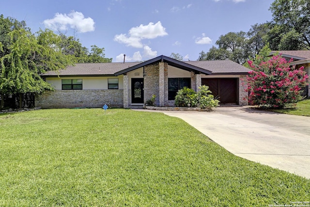 5738 Brenda Ln, San Antonio, TX 78240 - mid-century modern home featuring stone siding, a front yard, driveway, and an attached garage