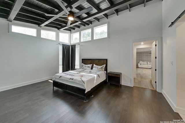 5738 Brenda Ln, San Antonio, TX 78240 - bedroom with multiple windows, dark wood-style flooring, a high ceiling, and a wood ceiling with exposed beams