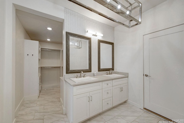 5738 Brenda Ln, San Antonio, TX 78240 - bathroom featuring marble finish flooring, double vanity, and a walk in closet