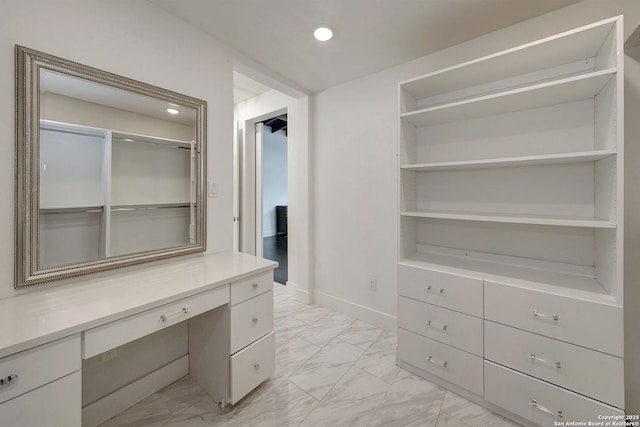 5738 Brenda Ln, San Antonio, TX 78240 - walk in closet featuring light marble finish flooring and built in study area
