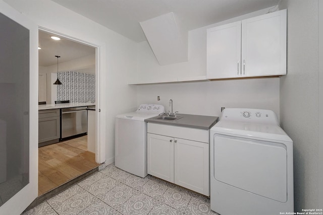 5738 Brenda Ln, San Antonio, TX 78240 - laundry room featuring cabinet space, washing machine and dryer, and light tile patterned floors