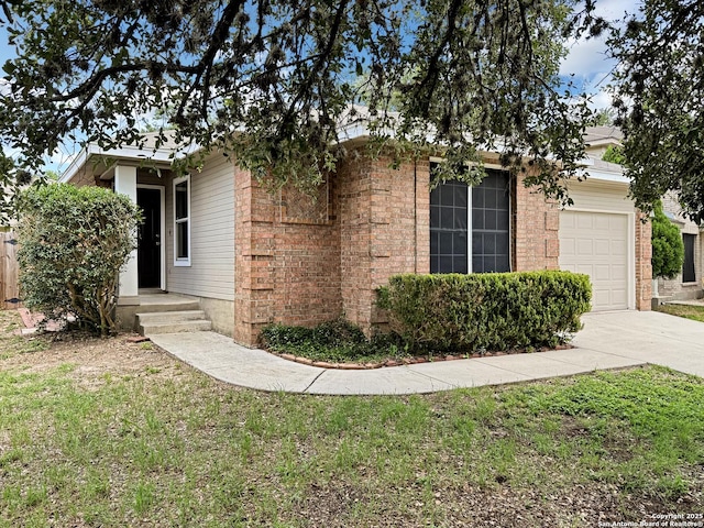 1222 Bobcat Pass, San Antonio, TX 78251 - view of front facade with concrete driveway, a garage, brick siding, and a front lawn
