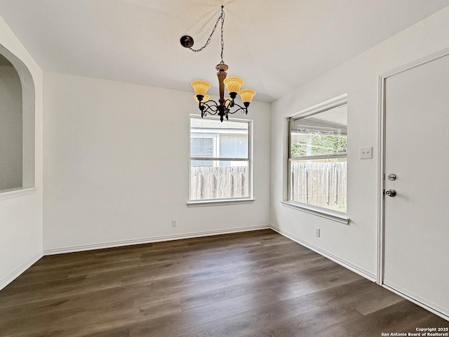 1222 Bobcat Pass, San Antonio, TX 78251 - unfurnished dining area with arched walkways, a chandelier, dark wood-type flooring, and vaulted ceiling