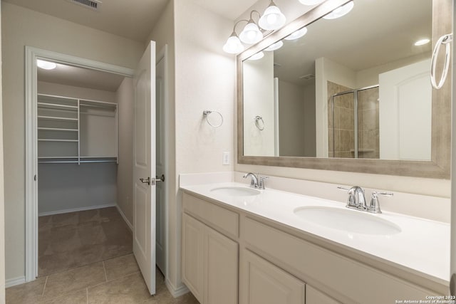 13119 Sulphur Trl, San Antonio, TX 78253 - bathroom with double vanity, a tile shower, tile patterned flooring, and a spacious closet