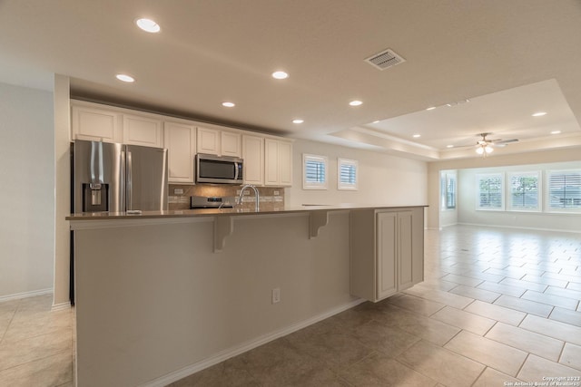 13119 Sulphur Trl, San Antonio, TX 78253 - kitchen with appliances with stainless steel finishes, plenty of natural light, recessed lighting, a kitchen breakfast bar, and decorative backsplash