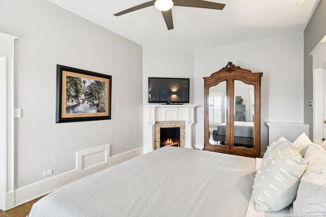 133 E Mistletoe Ave, San Antonio, TX 78212 - bedroom featuring a lit fireplace, ceiling fan, and wood finished floors