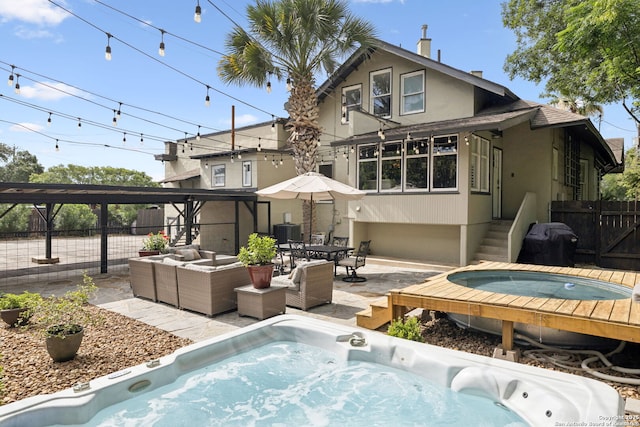 133 E Mistletoe Ave, San Antonio, TX 78212 - back of house with a hot tub, an outdoor living space, stucco siding, and a patio area