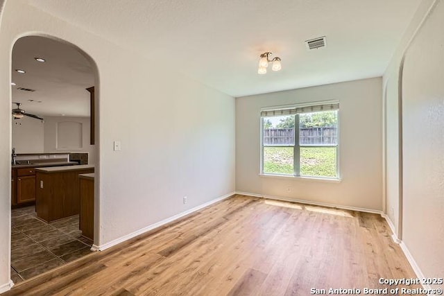 2727 Encino Riv, San Antonio, TX 78259 - empty room featuring wood finished floors, arched walkways, and ceiling fan