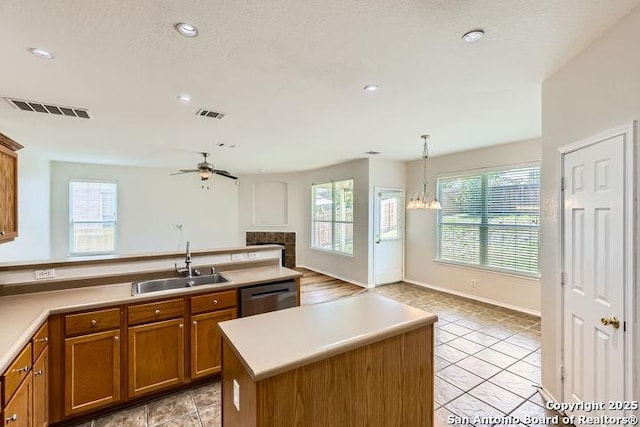 2727 Encino Riv, San Antonio, TX 78259 - kitchen featuring brown cabinets, a tile fireplace, healthy amount of natural light, ceiling fan, and recessed lighting