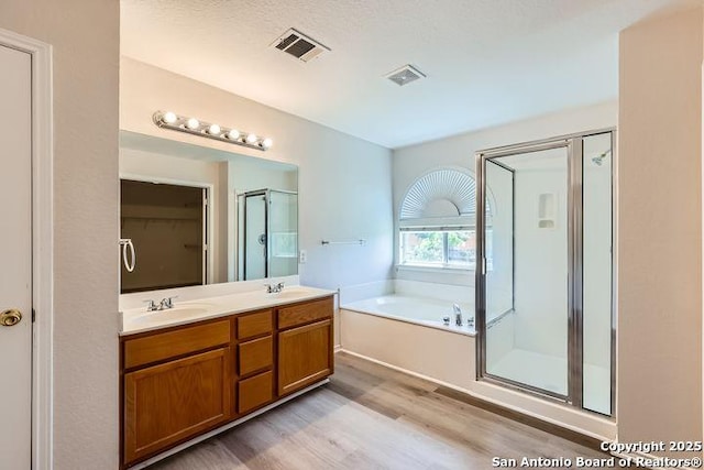 2727 Encino Riv, San Antonio, TX 78259 - full bath featuring wood finished floors, a stall shower, a bath, and double vanity