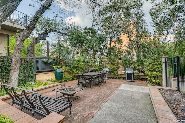117 Saint Dennis Unit 117, San Antonio, TX 78209 - fenced backyard featuring an outdoor fire pit, a patio, outdoor dining space, and a grill