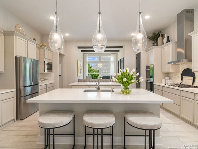 25022 Dulzura, San Antonio, TX 78261 - kitchen with appliances with stainless steel finishes, wall chimney range hood, a center island with sink, decorative backsplash, and recessed lighting