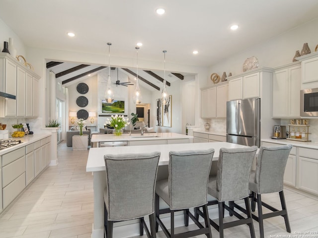 25022 Dulzura, San Antonio, TX 78261 - kitchen featuring stainless steel appliances, a center island with sink, decorative backsplash, a breakfast bar, and recessed lighting