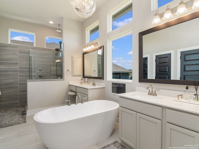 25022 Dulzura, San Antonio, TX 78261 - bathroom with walk in shower, vanity, a freestanding bath, and recessed lighting