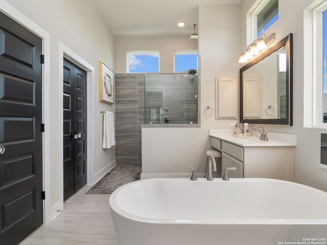 25022 Dulzura, San Antonio, TX 78261 - full bath with a freestanding tub, a walk in shower, vanity, and recessed lighting